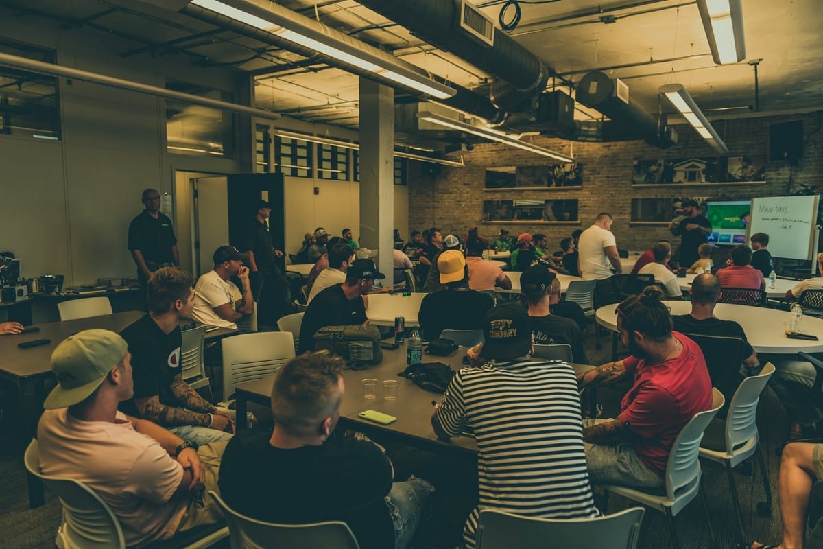A packed room of men of every age seated around tables at a Man Days gathering